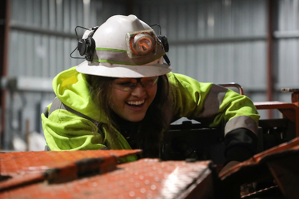 Photo of Skylar Elenbass working on mining equipment